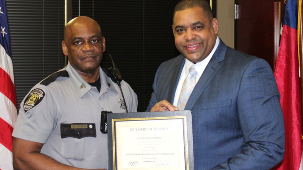 Kenneth McCormick, left, receives a service honor from Richmond County Sheriff Richard...