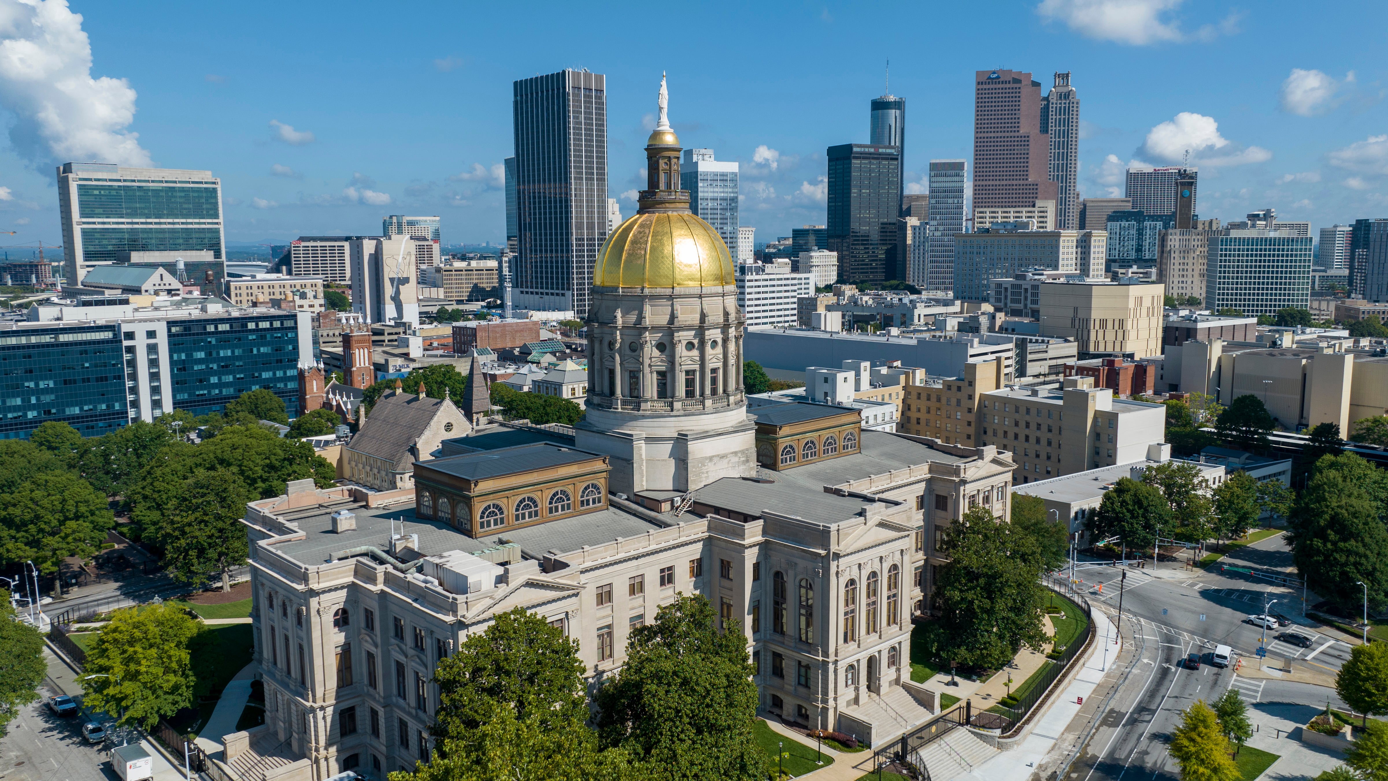 FILE - The gold dome of the Georgia Capitol gleams in the sun, Aug. 27, 2022, in front of the...