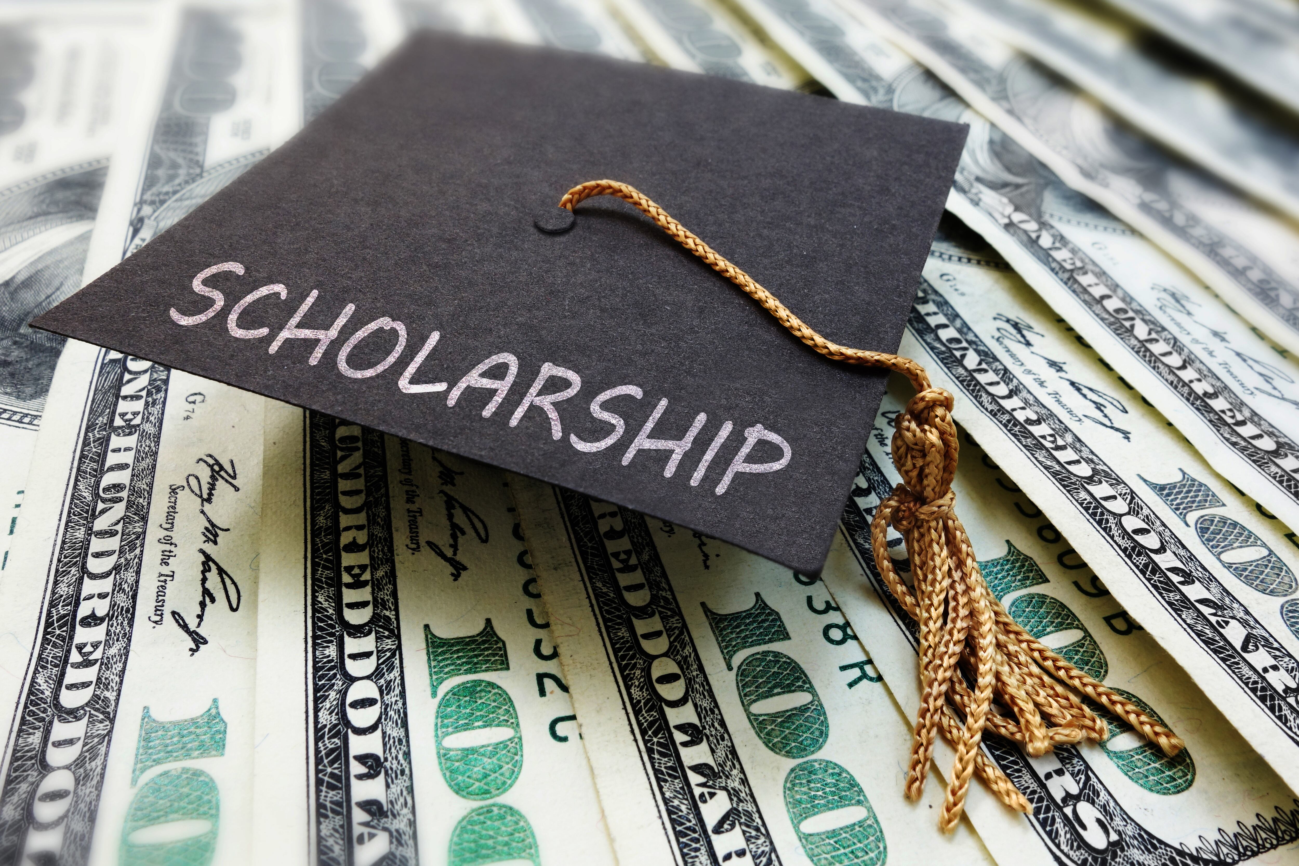 Scholarship graduation cap on money