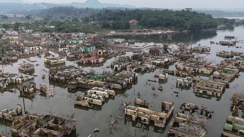 Long-submerged houses are exposed after prolonged drought lowers the water level of Karian...