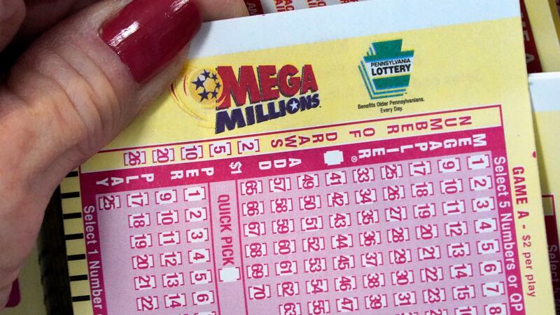 FILE - A Mega Millions wagering slip is held in Cranberry Township, Pa., Jan. 12, 2023. The...