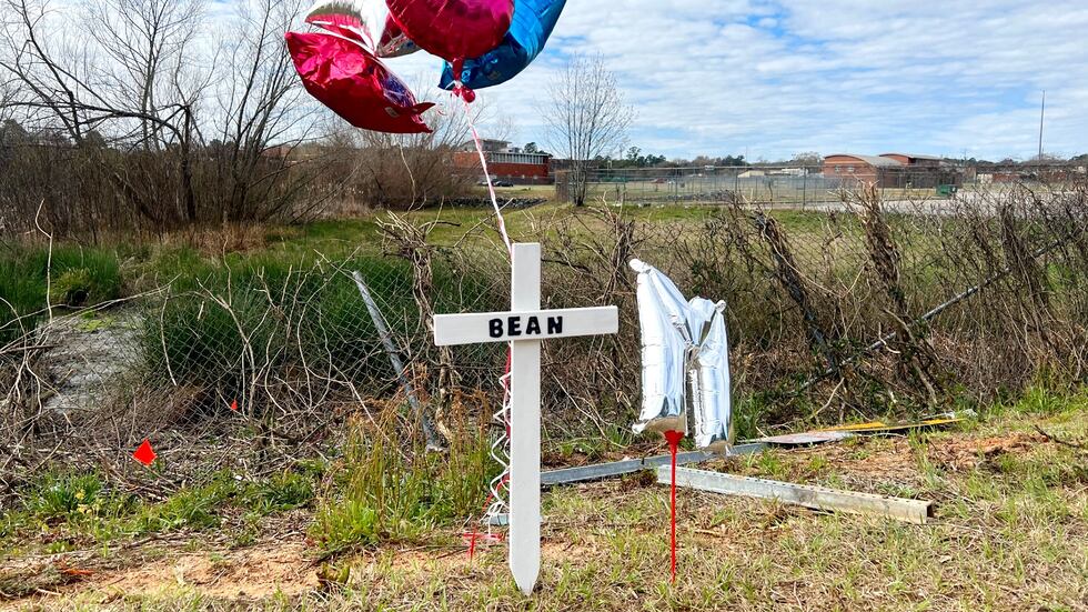 A cross and balloons are displayed in memory of hit-and-run victim Jerry McKinnon near Butler...